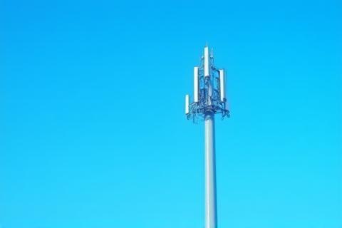 Telecommunications tower against a clear sky.
